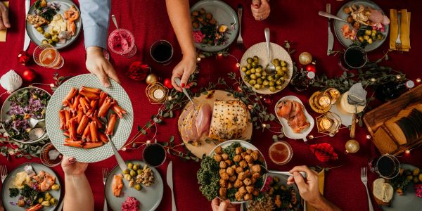 Holiday dinner with ham and various dishes on a festive table.