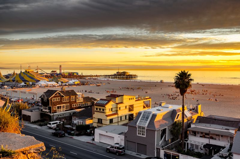 Golden sunset over Santa Monica beach, site of expensive beach homes and famous Santa Monica pier, in southern California.
