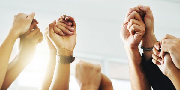 People holding hands in unity and support.