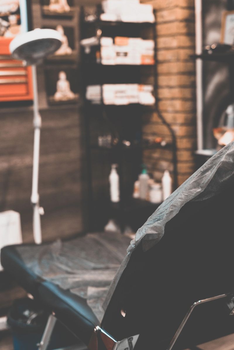 Tattoo salon. The tattoo master is tattooing a man on his shoulder. Tattoo machine, safety and hygiene at work. Close-up, tinted, tattooist.