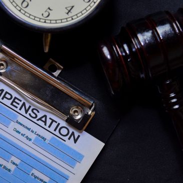 Gavel, clock, and compensation form on clipboard.