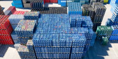 A large outdoor storage of stacked beverage crates.