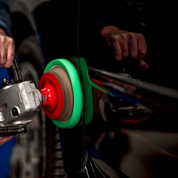 Car polishing with a buffer machine.