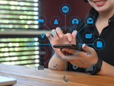 Woman using a smartphone with a circular overlay of various blue digital communication icons.