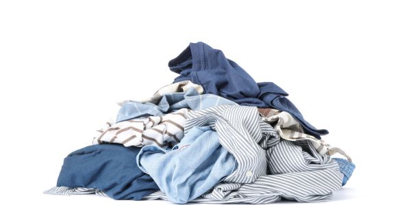 Pile of assorted clothes on a white background.