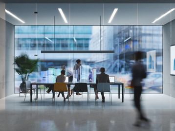 People in a modern office meeting with city view.
