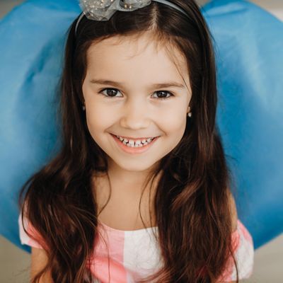 Little girl smiling in a dental chair