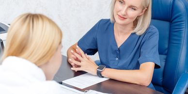Healthcare professional attentively consulting with a patient in an office.
