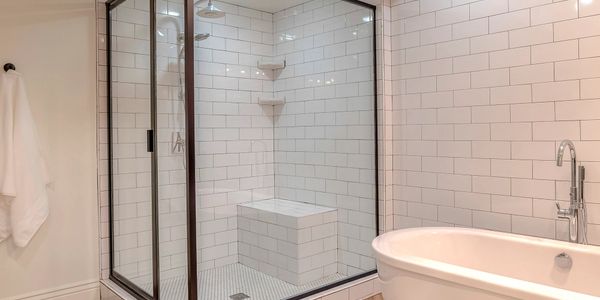 Modern bathroom with glass shower and freestanding bathtub.