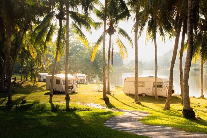 Wonderful morning of family vacation travel RV nearby lake, holiday trip in motorhome, Caravan car Vacation. Beautiful Nature Thailand’s valley landscape.