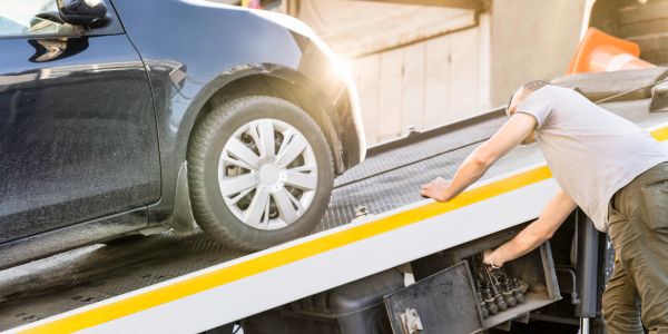 Car being loaded onto a tow truck.