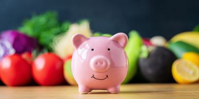 piggy bank with fruit in background