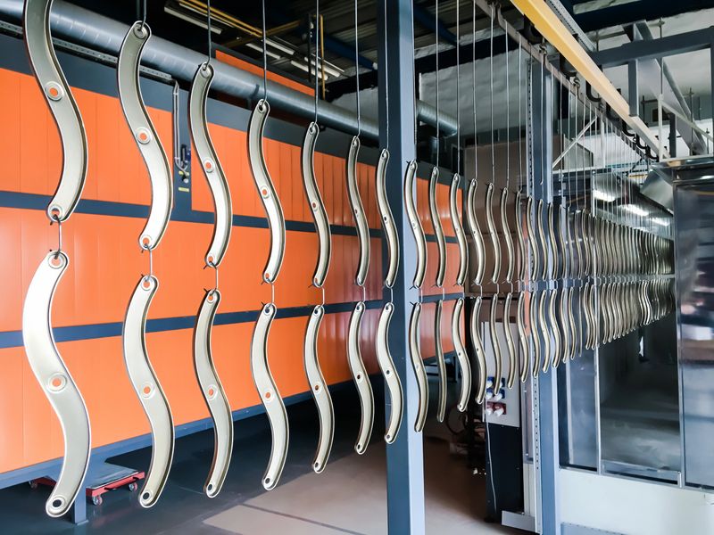 Powder coating of metal parts in factory