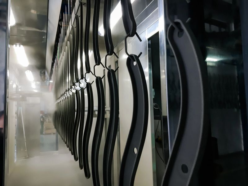 Powder coating of metal parts in factory