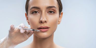 Woman receiving a lip injection.