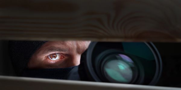 Private Investigator looking out window