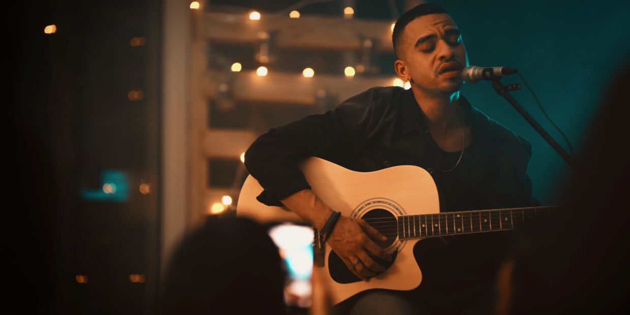 Man playing acoustic guitar and singing.