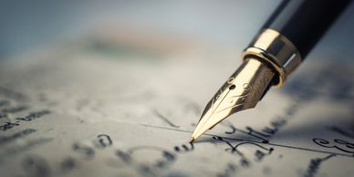 Close-up of a fountain pen writing on paper.