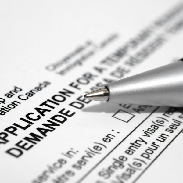 Close-up of a pen on a visa application form.