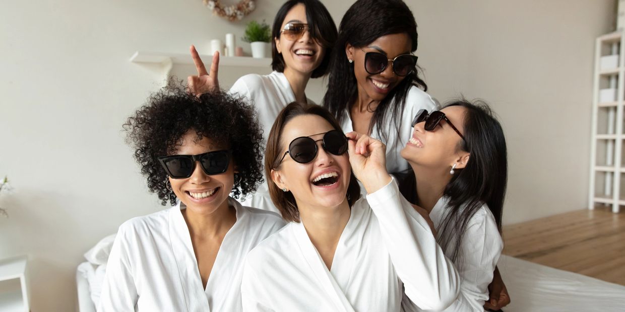 Group of girls  all wearing white robes and black sunglasses.  IV drip party Farragut & Knoxville.