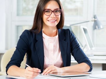Smiling businesswoman working at her desk.
