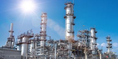Oil refinery under bright sunlight.