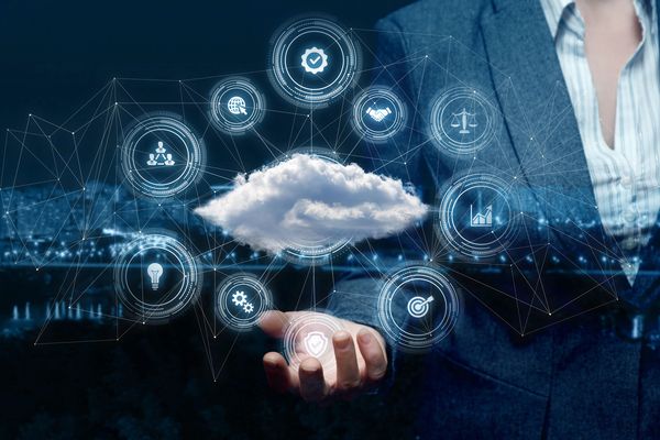 Businessman holding digital cloud with technology and network icons.
