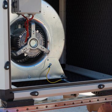 Industrial blower fan inside machinery.