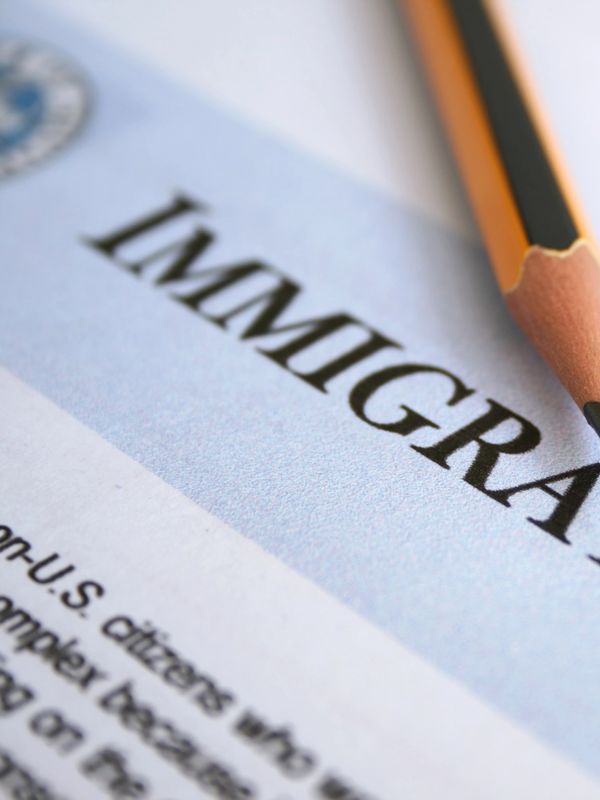 Pencil pointing at the word 'Immigration' on a document.