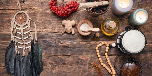A collection of spiritual and natural items on a wooden surface.