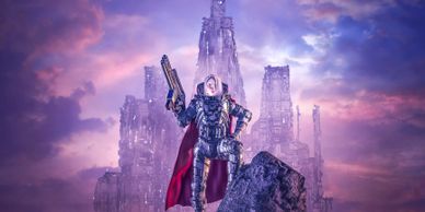 A futuristic warrior stands confidently with a large gun against a dramatic purple sky.