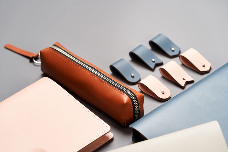 Set of handmade leather goods, key holder rings, wallet, purse, notepad, handbook. Handcrafted leather goods, close-up