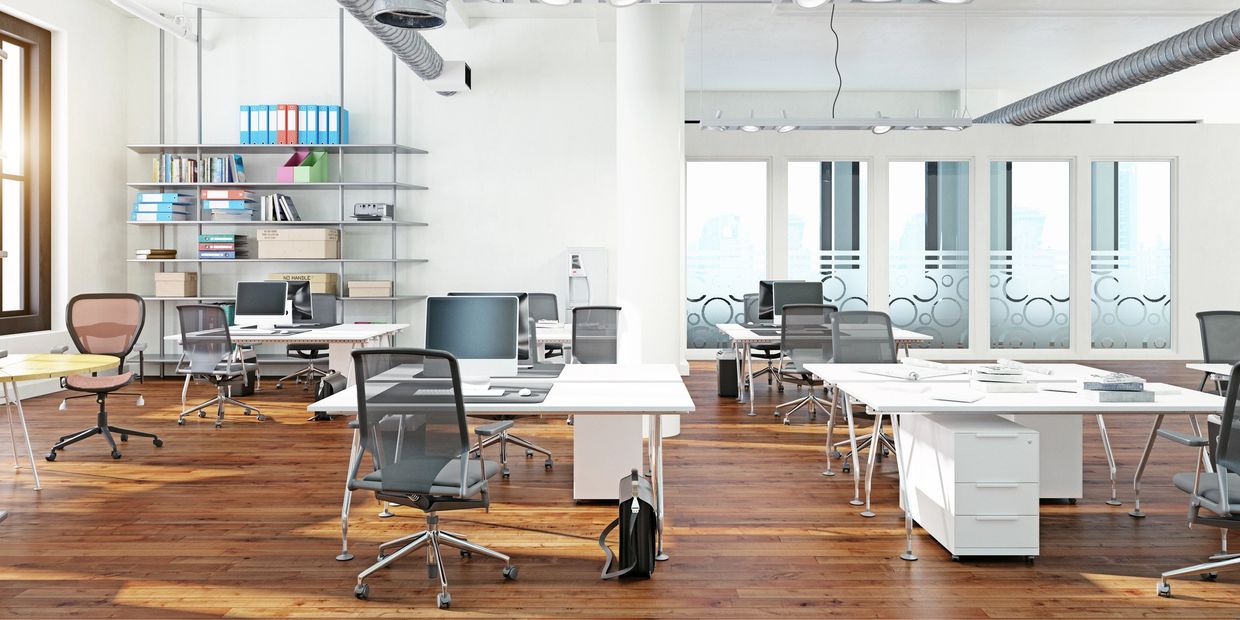 Chic office with white desks and modern furnishings after professional house cleaning