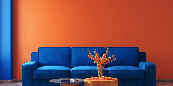 Blue sofa against an orange wall.