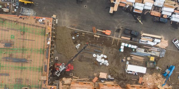 Aerial view of a construction site with workers and materials.