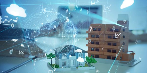 Hand interacting with virtual smart home technology and architectural models.
