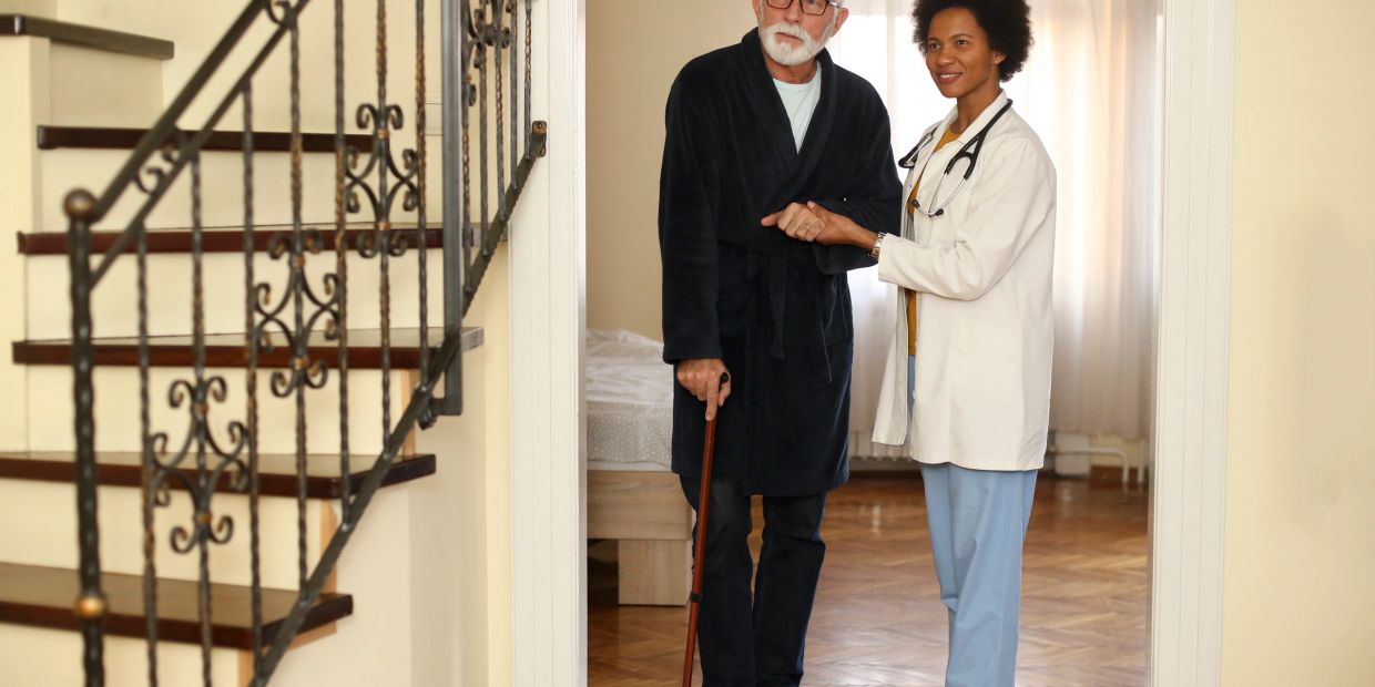 Compassionate nurse providing home care outdoors.