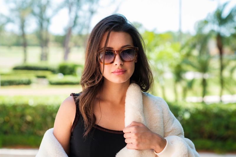 Beautiful young woman outdoor fashion portrait wearing sunglasses.