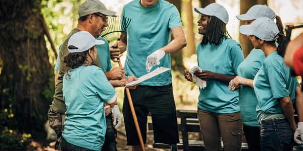 Volunteers packing food items at a community center table.