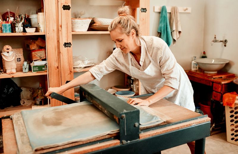 Shot of a female artisan working in her pottery workshop