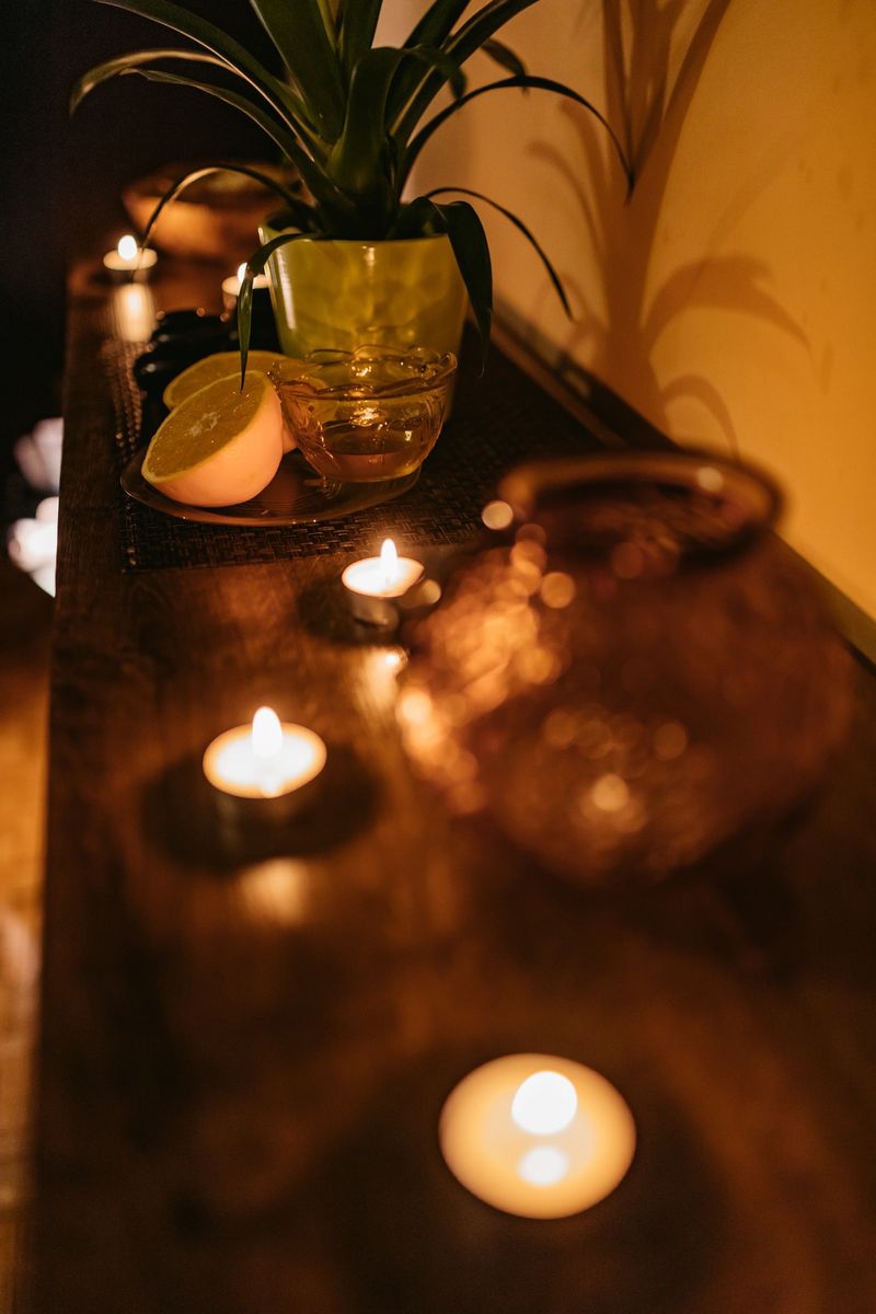 Closeup of burning candles spreading aroma on table in a spa room. Zen and relax concept.