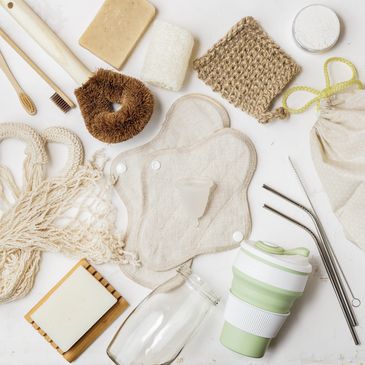 Sustainable personal care and reusable items arranged on a white surface.