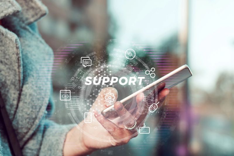 Close-up of woman contacting online support while using mobile phone.