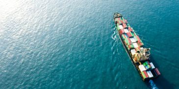 Cargo ship sailing in the ocean with containers.