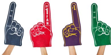 Four colorful foam fingers held up, each showing the number one.