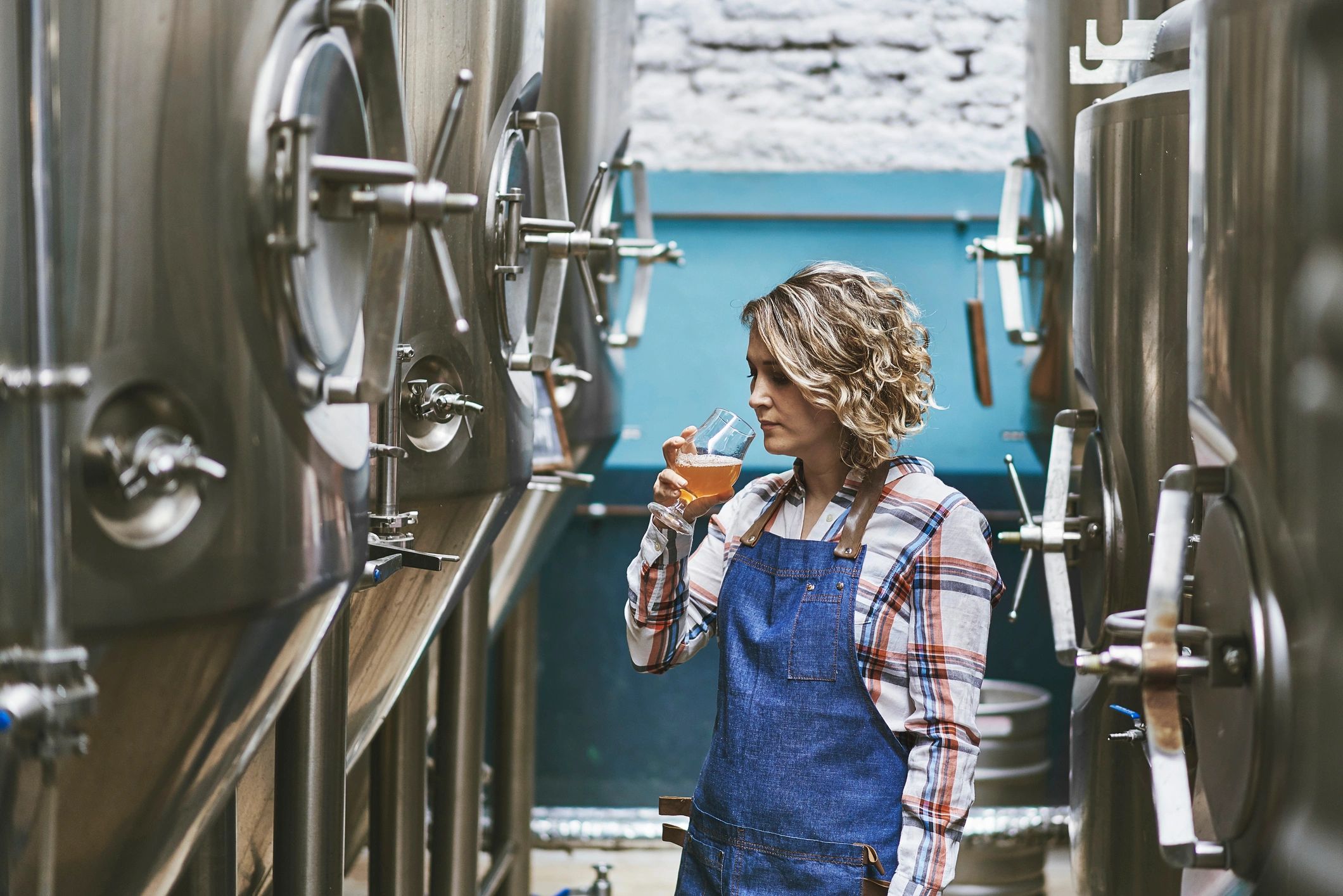 Craft brewer examining beer sample
