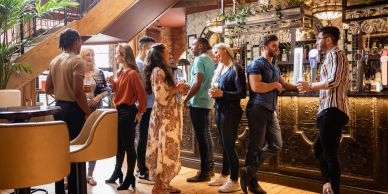 People socializing in a bar with drinks.