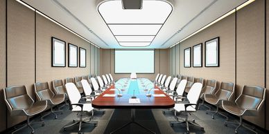 Modern conference room with a long table and chairs.