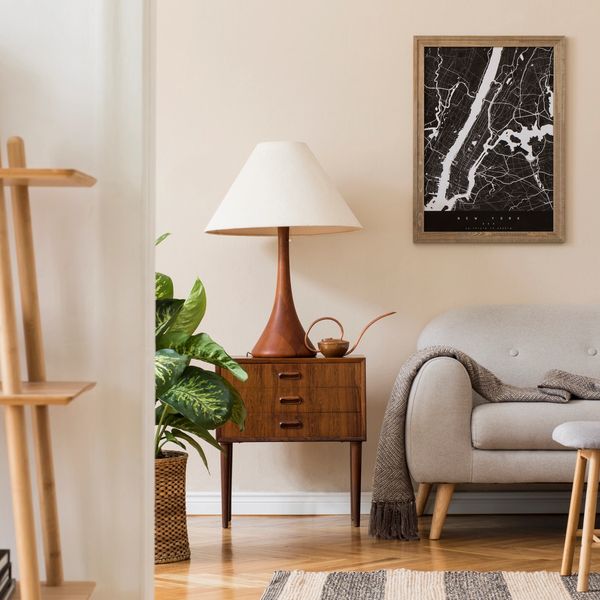 Cozy living room corner with a sofa, lamp, and plant.