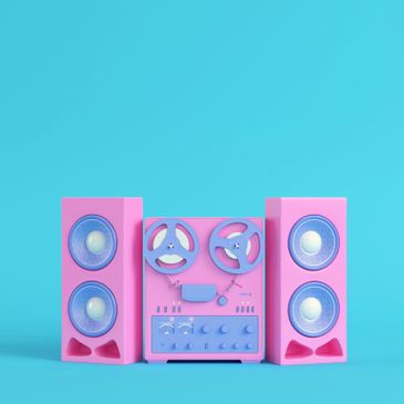 Pink vintage reel-to-reel tape recorder with speakers on a blue background.